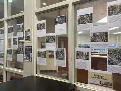several research papers taped up to a glass window.